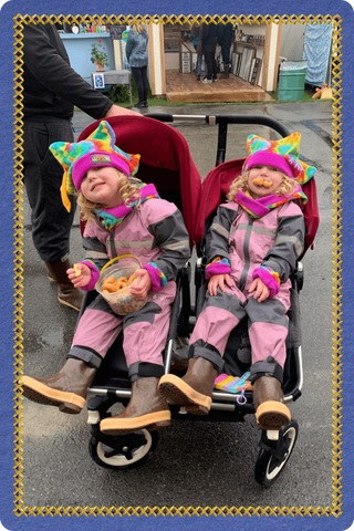 Children wearing colorful Twinkle Toes hats and accessories during a vendor market in Palmer, Alaska