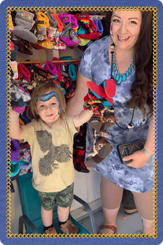 Children wearing colorful Twinkle Toes hats and accessories during a vendor market in Palmer, Alaska