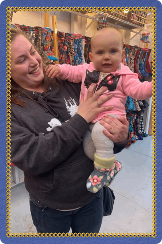Young child wearing Twinkle Toes socks while visiting the Palmer, Alaska shop and vendor market booth