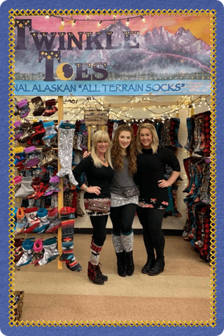 Twinkle Toes team at their Palmer, Alaska shop showcasing all-terrain socks and Wild Outerwear products